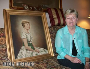 Linda Hern, Ruth Lyons' niece, with a portrait of Candy Newman, Ruth Lyons' daughter
